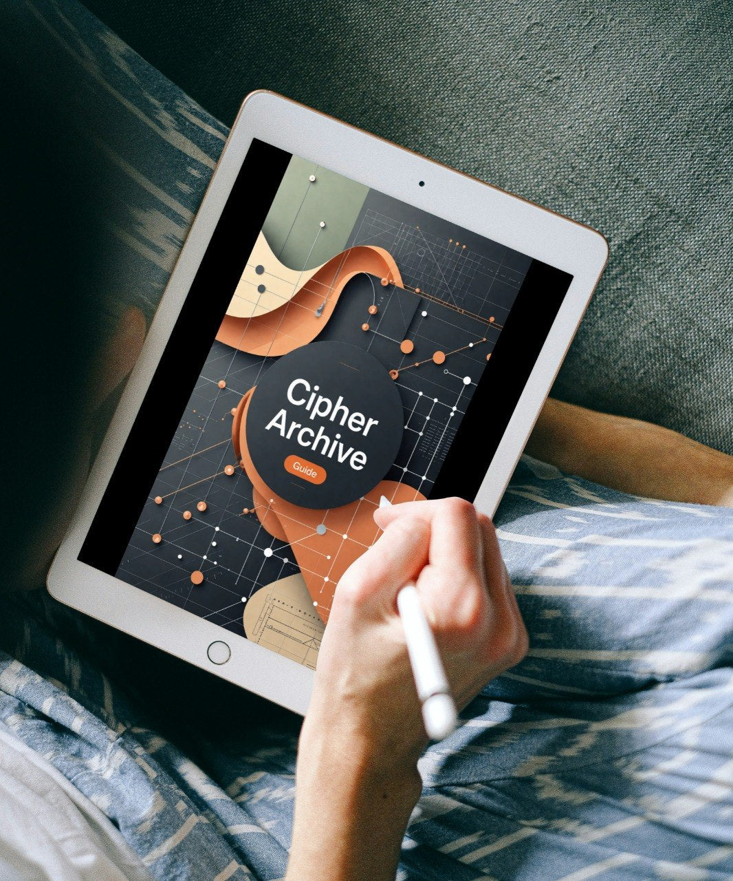 A person lying on a bed or couch holding a white tablet with a stylus, showing a digital cover for 'Cipher Archive' on the screen.