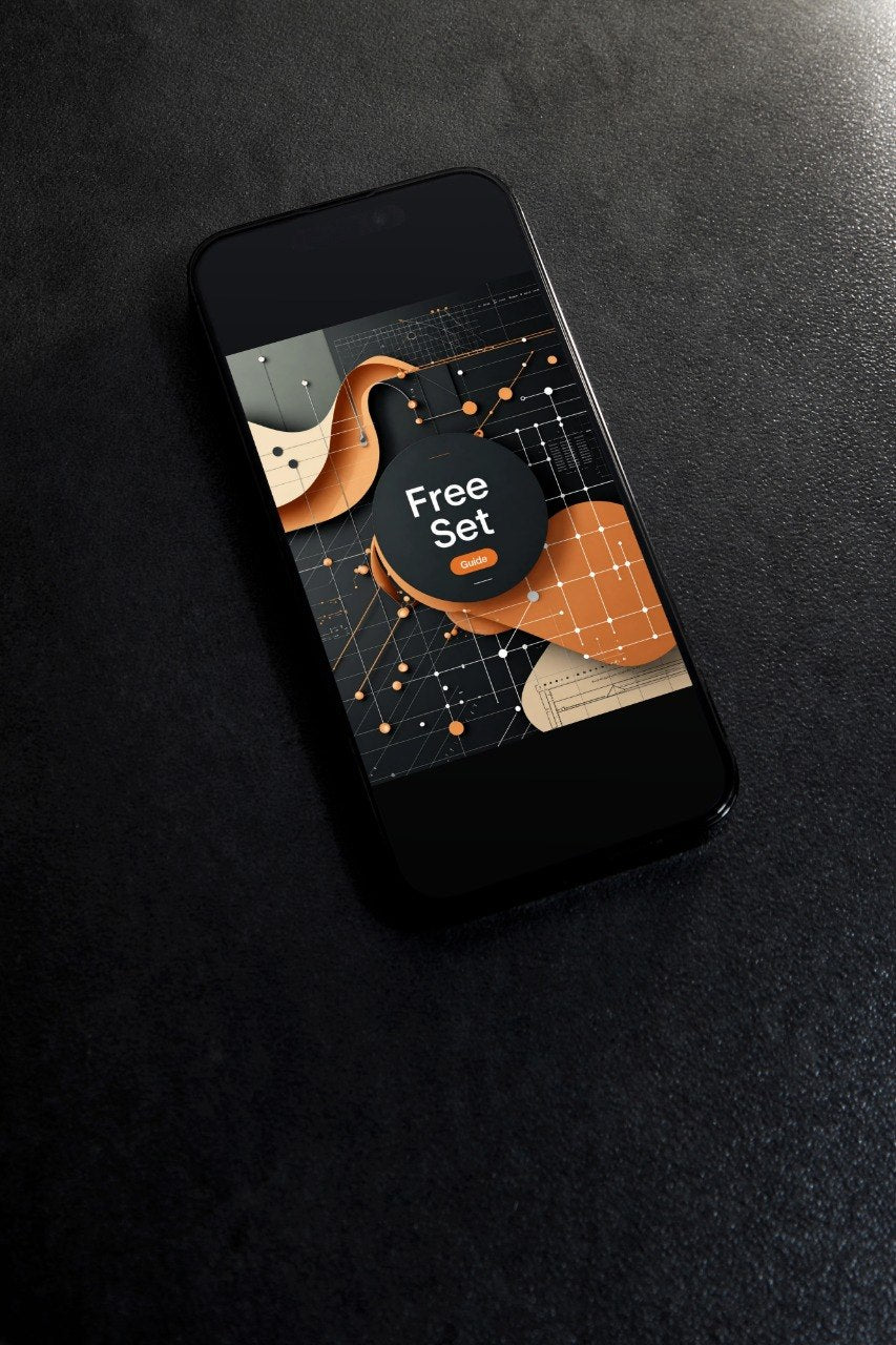 A black smartphone lying diagonally on a dark textured surface, displaying a promotional app or game screen with abstract orange, beige, and black shapes and the words 'Free Set'.