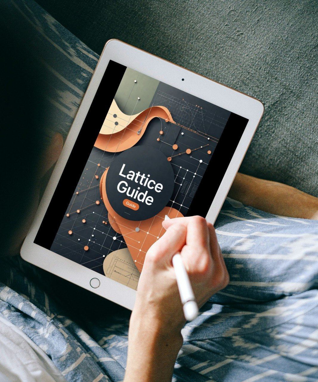 A person lying on a couch holds a tablet with a stylus, showing a digital cover titled "Lattice Guide" on the screen.