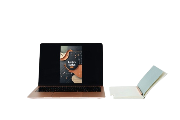 A black laptop with a rose gold base is shown open, displaying a book cover on its screen, next to a white notebook with a light blue cover and a rose gold endcap on a solid white background.